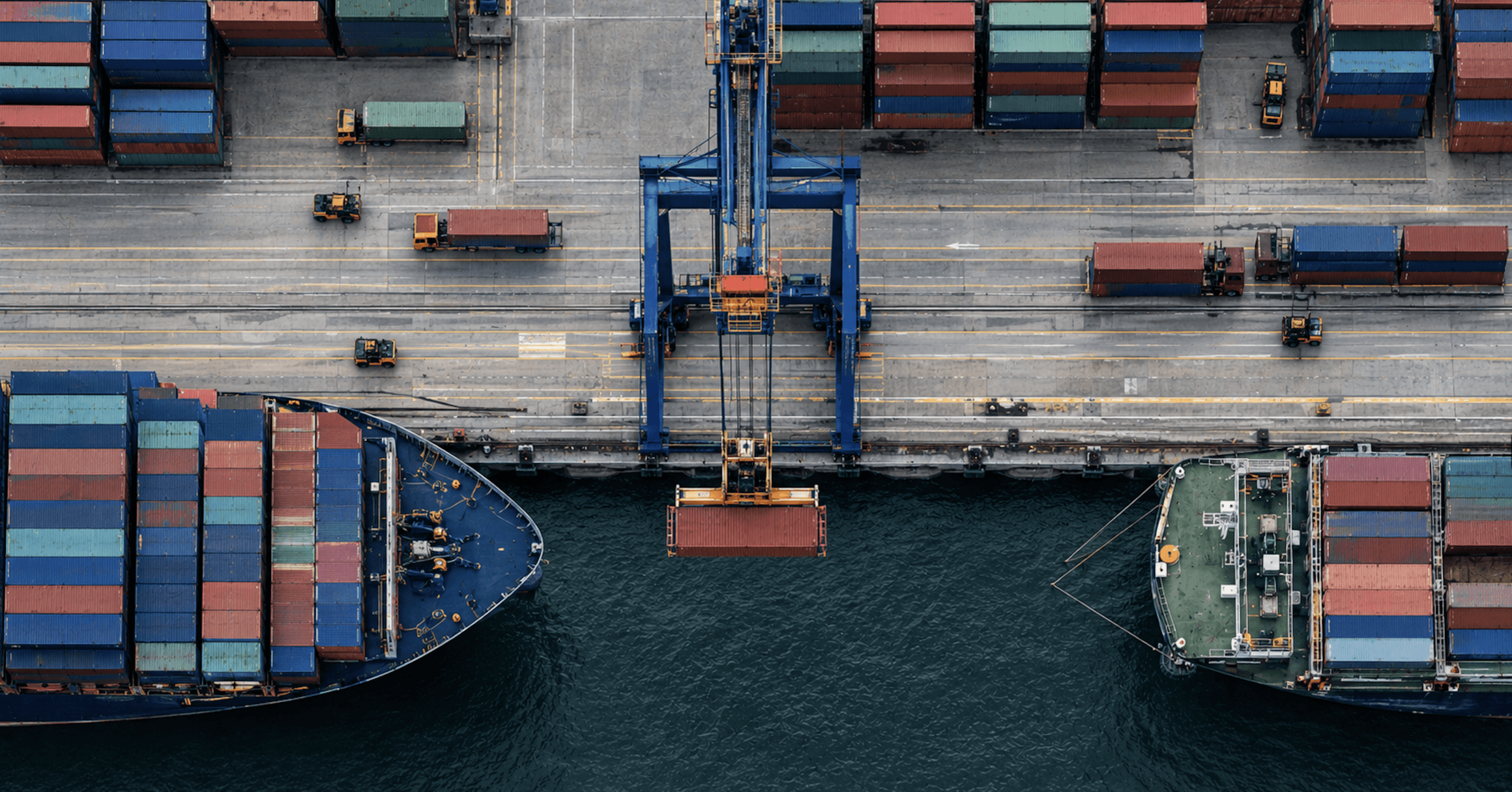 Aerial view of a shipping port with cargo containers, cranes, and vessels representing the movement of ecommerce operations during replatforming